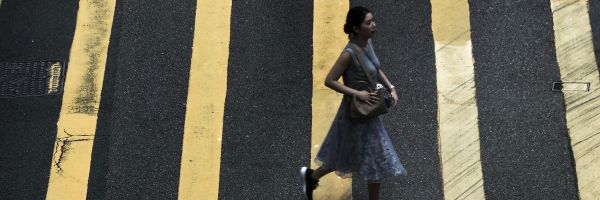 Woman walking across a street crossing