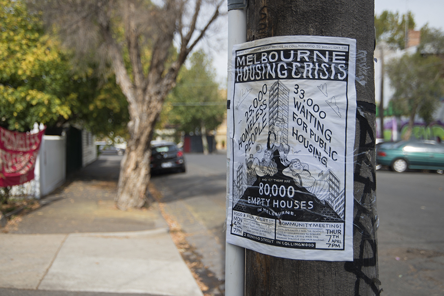 Photograph of a poster on a light pole in an urban street. Heading reads Melbourne Housing Crisis. 25,000 homeless, 33,000 waiting for public housing, 80,000 empty houses.
