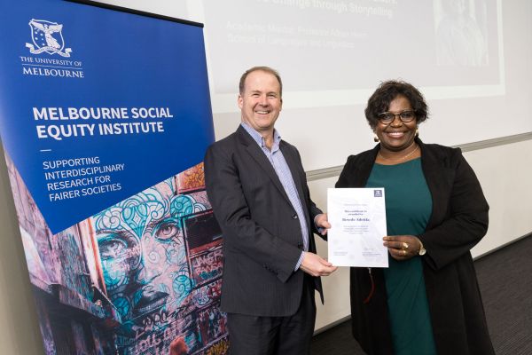 Mark Cassidy presents a certificate to Bosede Adetifa