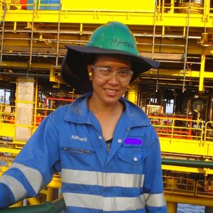 Woman in in hard hat and industrial overalls