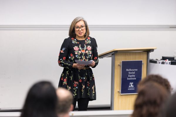 Charlene Edwards speaking next to a lectern