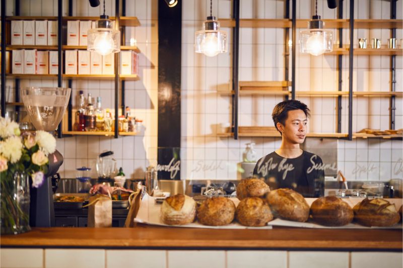 Young person working at a cafe counter