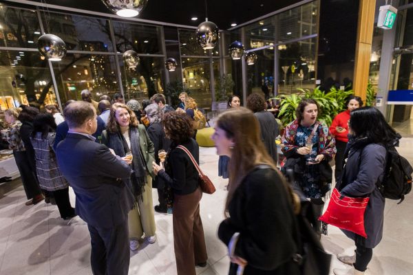 People chatting over refreshments in the foyer
