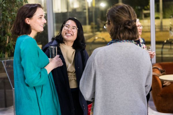People chatting over refreshments in the foyer