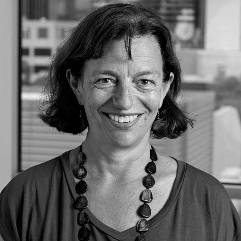 Black and white photo of Karen Block. She has short straight hair and is wearing a beaded necklace