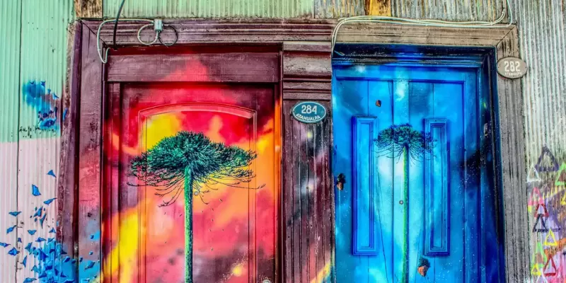 Street art painting of two doors with trees and colour backgrounds